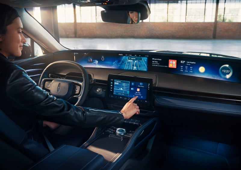 The driver of a 2024 Lincoln Nautilus® SUV interacts with the center touchscreen. | Wallace Lincoln in Fort Pierce FL